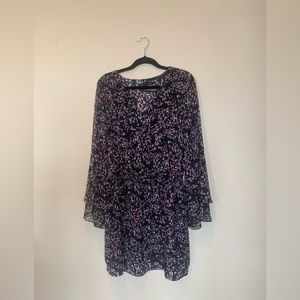 The brand of this dress is black and white. This dress has a v cut.